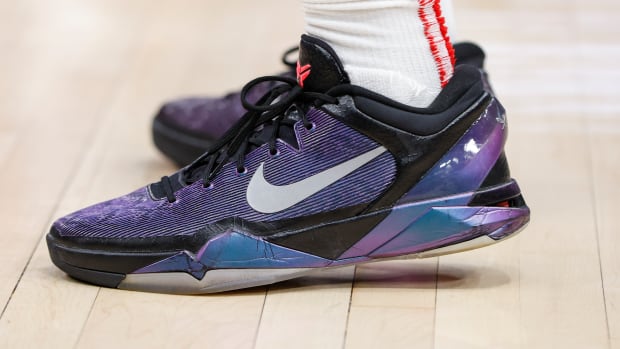 View of purple and black Nike Kobe shoes.